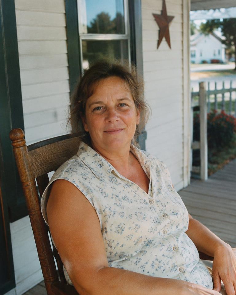 A resident sitting on her front porch